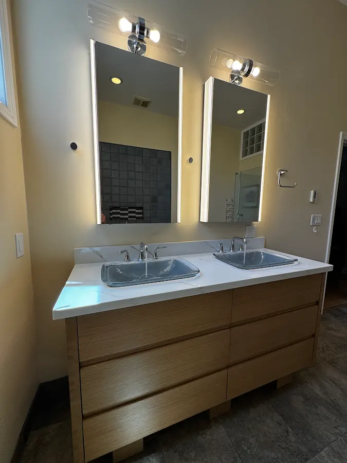 Clean double vanity with two mirrors and wall lights