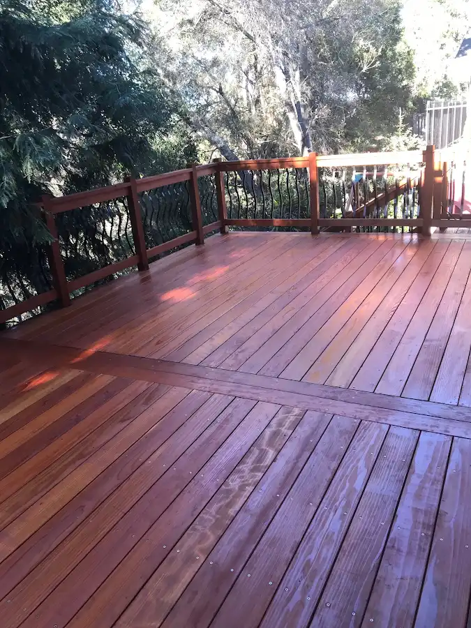 Refinished wood deck surrounded by trees