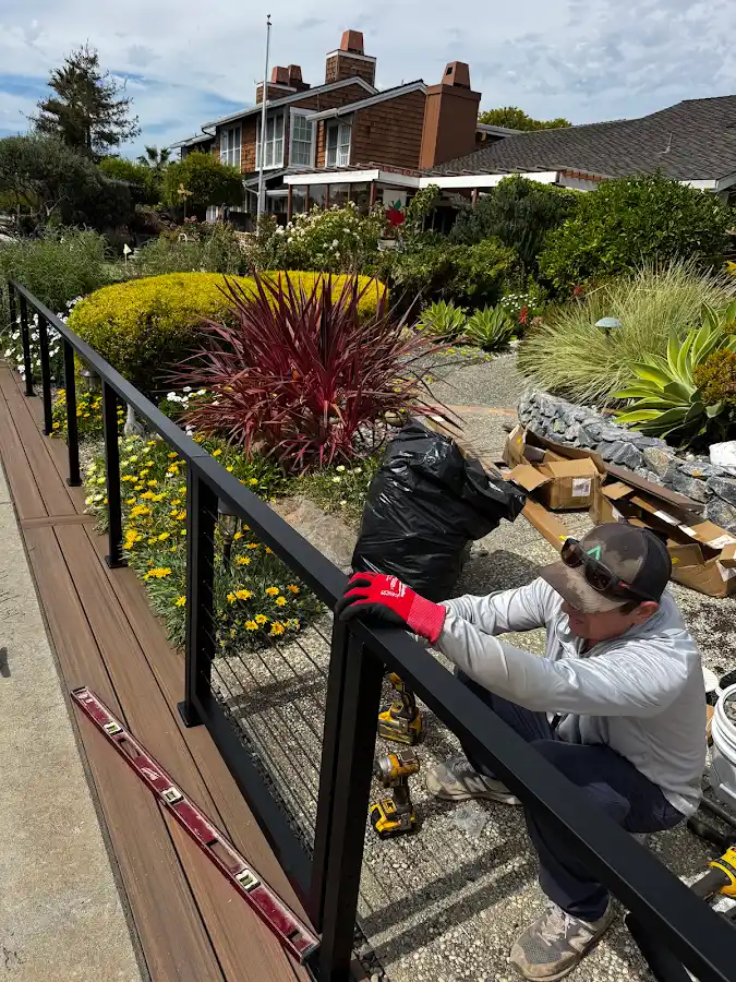 Railing installation in progress beside a waterfront deck