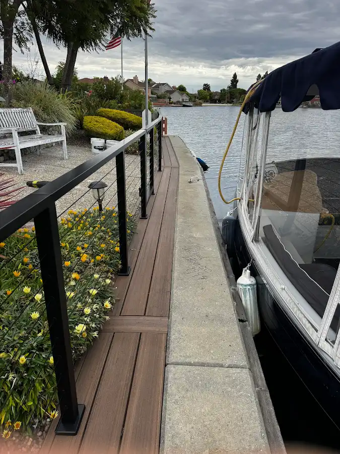 Waterfront deck walkway with a black railing