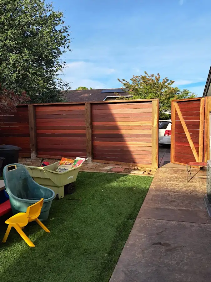 Backyard wood fence with an open garden gate