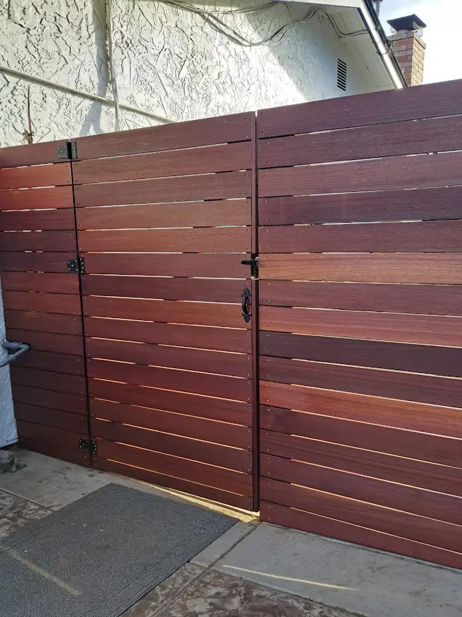 Horizontal wood gate with black hinges and hardware