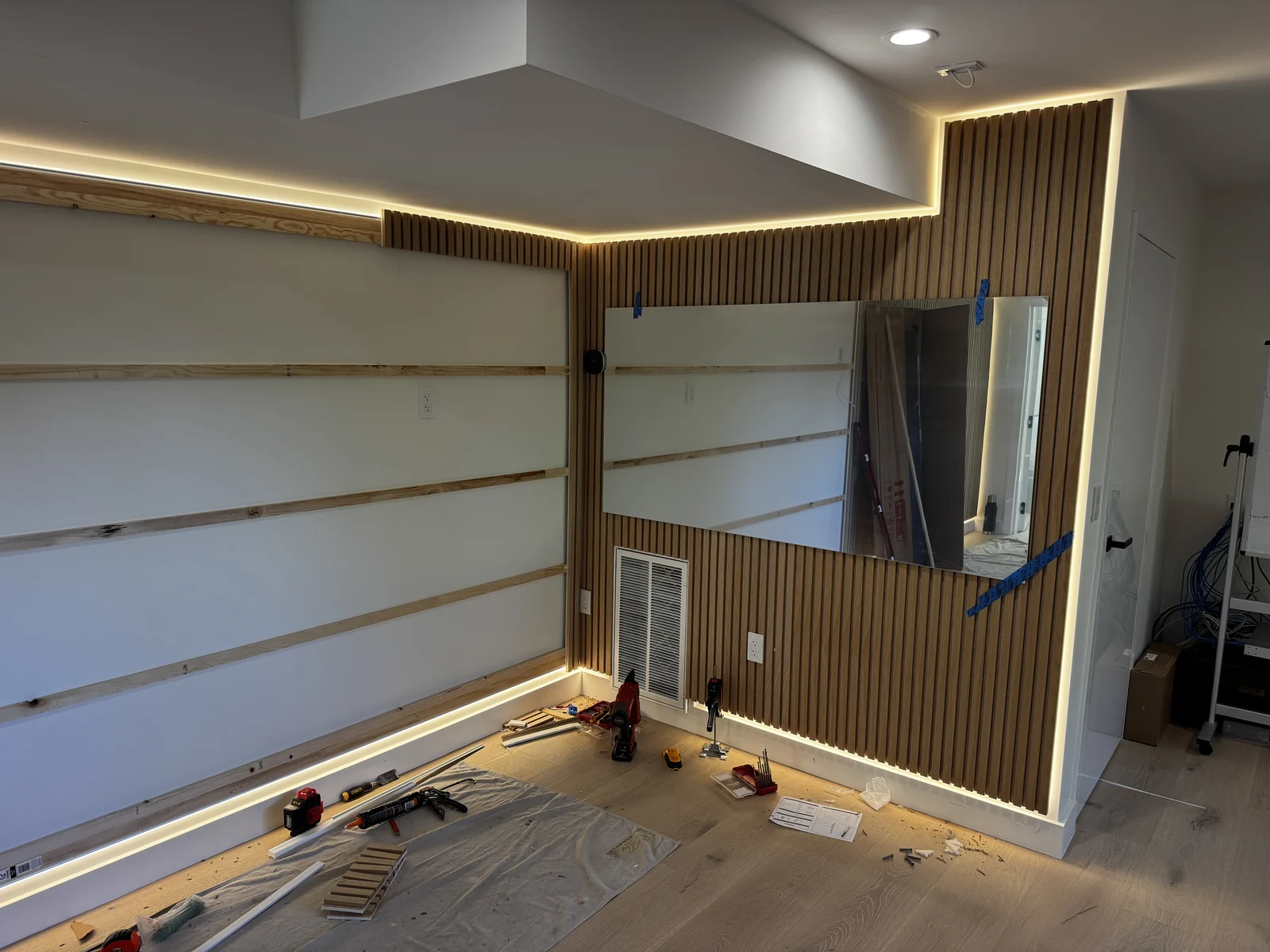 Custom media wall and storage installation in progress