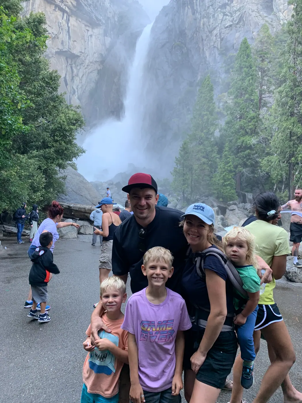 Ivan with his family beside a waterfall