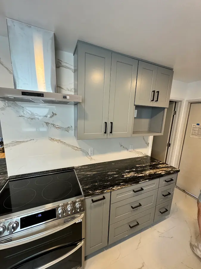 Gray wall cabinets and dark kitchen countertop details