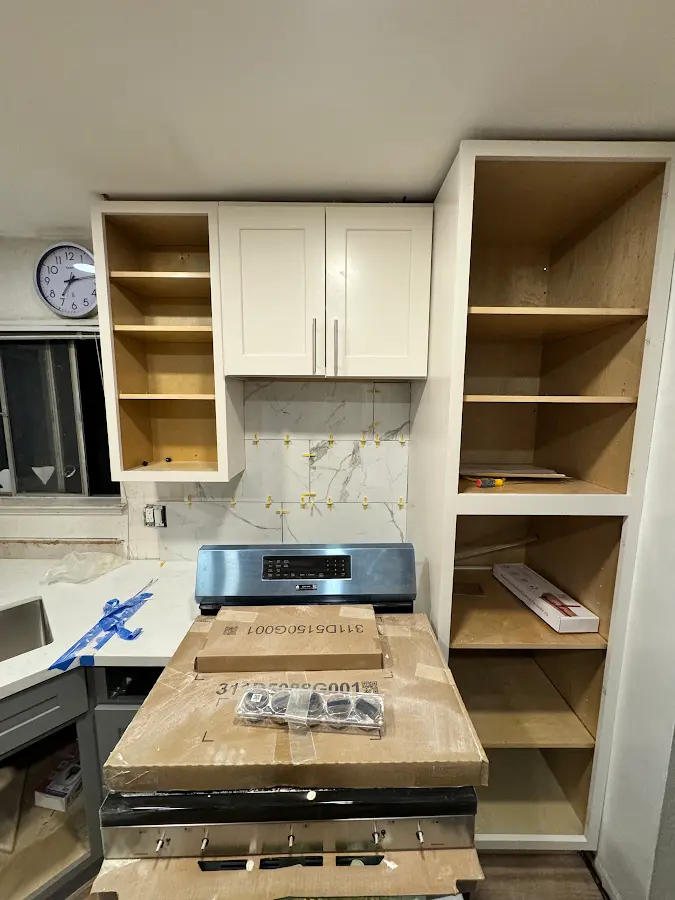 Kitchen cabinet and backsplash installation in progress