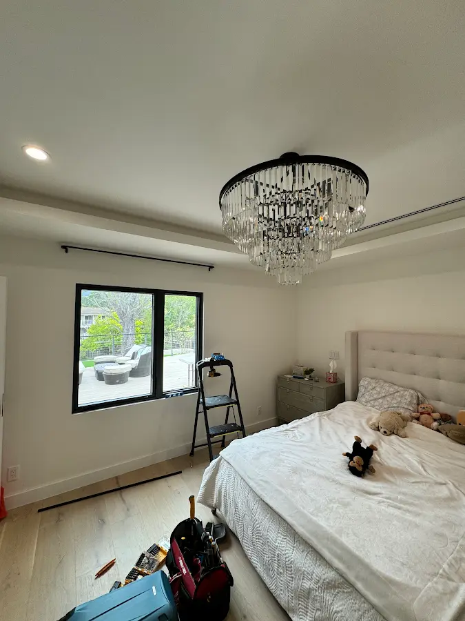 Chandelier installation in a bedroom
