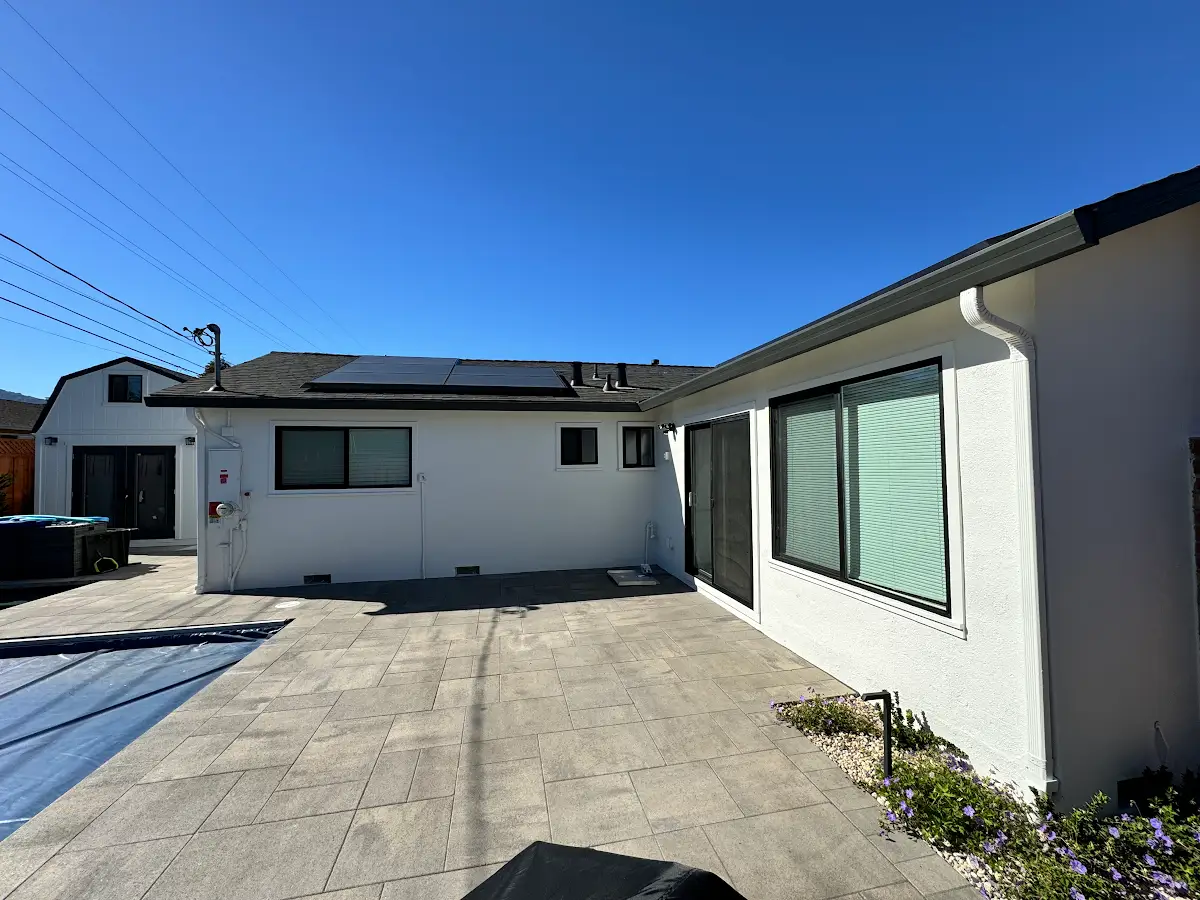 Exterior painting: white stucco walls around a backyard patio