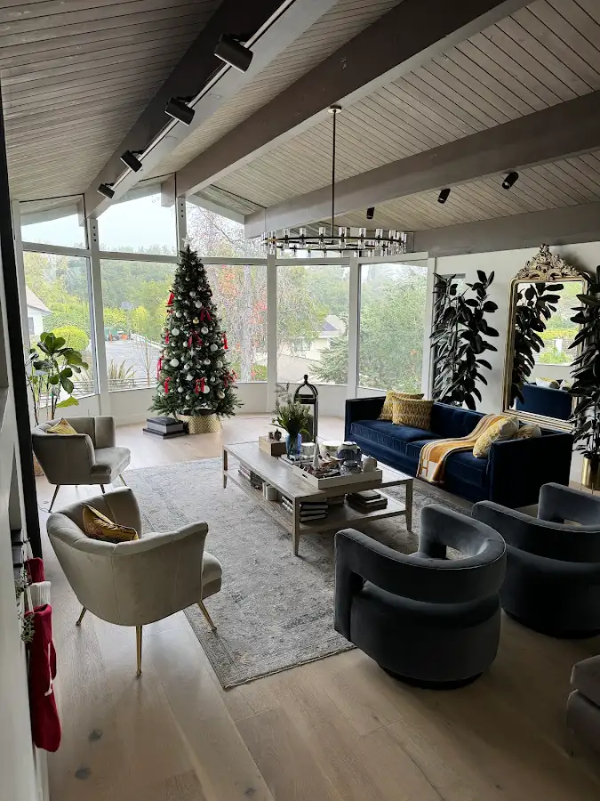 Living room with a painted beamed ceiling and tall windows